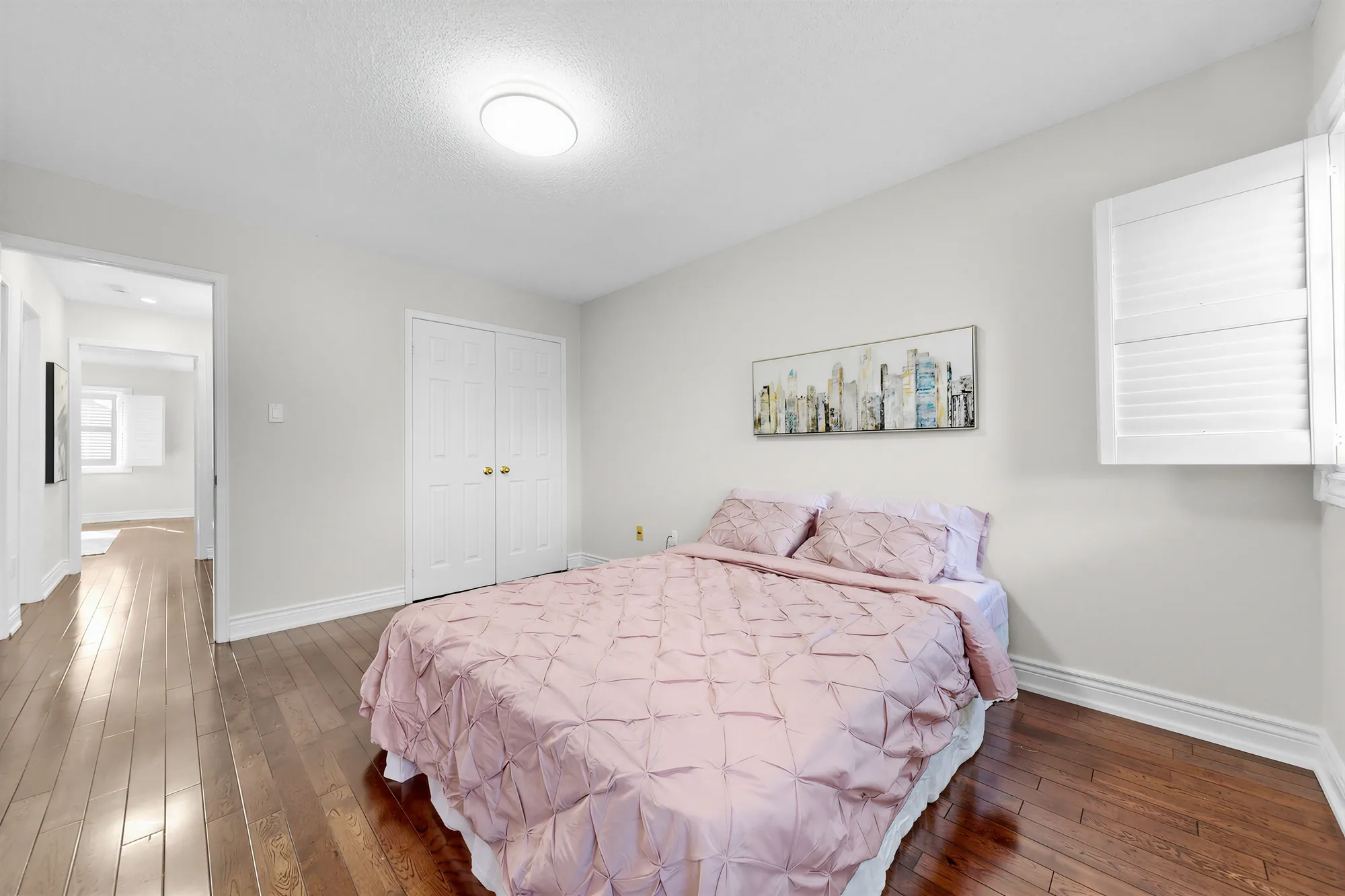 The second front bedroom toward its double closet and the door to the hall
