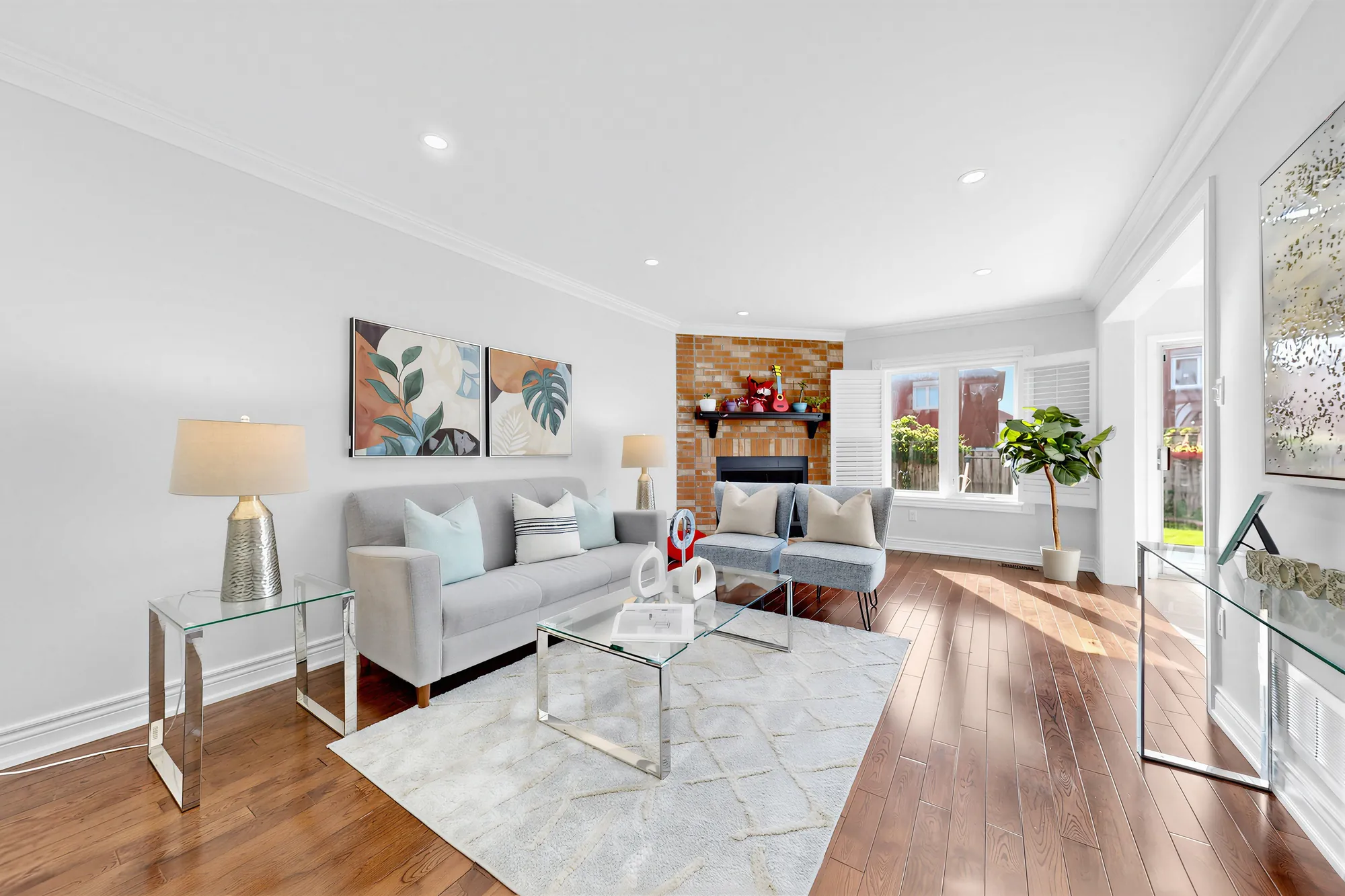 The living room toward the back: the fireplace, a window with shutters, a doorway to the kitchen at the right